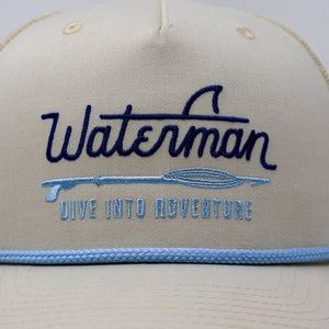 Beige cap with 'Waterman' logo and text on a white background