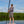 Person on a paddleboard with mangroves and blue sky in the background