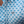 Close-up of a shirt with blue dog pattern and logo on a white background