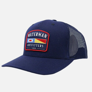 Navy blue cap with a patch featuring 'Waterman Outfitters' on a white background